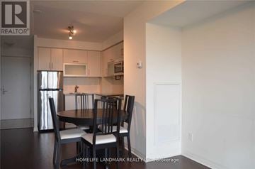Toronto (Henry Farm) condo for rent - A kitchen with a table and chairs in the foreground.