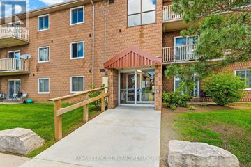London South (South X) condo for rent - A brick apartment building with a red roof and a balcony.