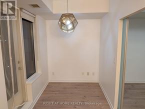 Toronto (Niagara) condo for rent - A room with a window and a wooden floor.
