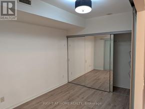 Toronto (Niagara) condo for rent - A room with a sliding glass door and a wooden floor.