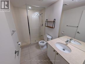 Toronto (Niagara) condo for rent - A bathroom with a toilet, sink, and walk-in shower.