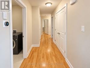 Ottawa fourplex for rent - A hallway with a washing machine in the doorway.