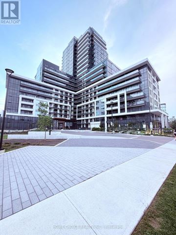 Oakville (Jm Joshua Meadows) condo for rent - A modern multi-story building with a glass facade and a landscaped courtyard in front.
