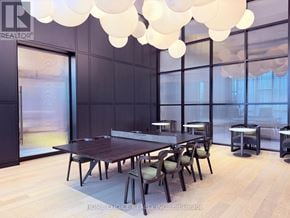 Oakville (Jm Joshua Meadows) condo for rent - A dining room with a long table and chairs.