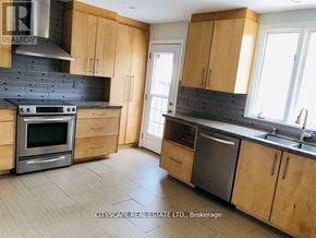 Oakville (Mo Morrison) apartment for rent - A kitchen with wooden cabinets and a black stove top oven.