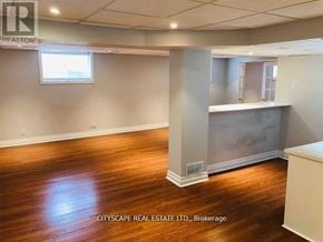 Oakville (Mo Morrison) apartment for rent - A room with wooden floors and a large window.