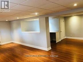 Oakville (Mo Morrison) apartment for rent - A room with wooden floors and white walls, with a window and a door visible.