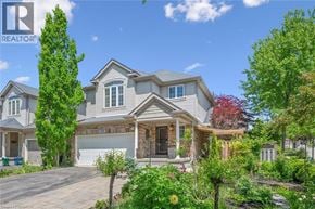 Kitchener apartment for rent - A large house with a driveway in front of it.
