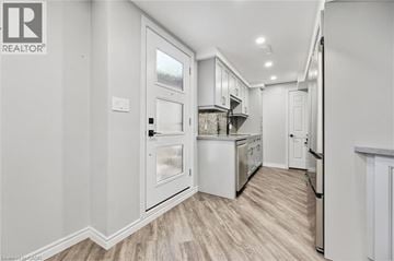 Kitchener apartment for rent - A kitchen with white cabinets and a refrigerator.