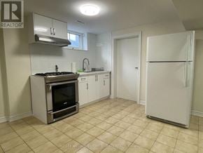 Toronto (Maple Leaf) apartment for rent - A kitchen with a stove top oven and a refrigerator.