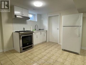 Toronto (Maple Leaf) apartment for rent - A kitchen with a stove top oven and a refrigerator.