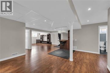 Smithville apartment for rent - A spacious living room with hardwood floors and a black rug in the center.