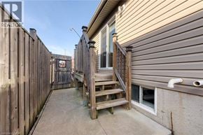 Smithville apartment for rent - A wooden deck with stairs leading to a door in a residential area.