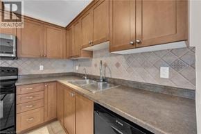 Smithville apartment for rent - A kitchen with wooden cabinets and a black dishwasher.