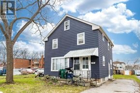 Cambridge apartment for rent - A blue house with a bicycle parked in front.