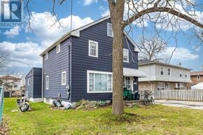 Cambridge apartment for rent - A blue house with a tree in front of it.