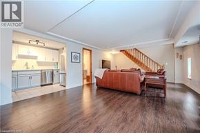 Waterloo condo for rent - A bedroom with a bed, a couch, and a staircase.