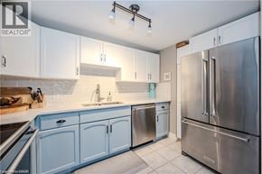 Waterloo condo for rent - A kitchen with a refrigerator, sink, and cabinets.
