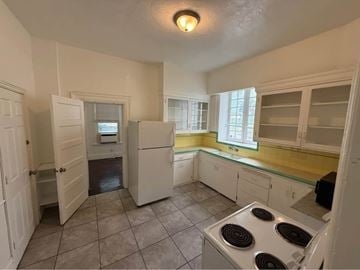 Salt Lake City apartment for rent - A kitchen with a stove top oven and a refrigerator.