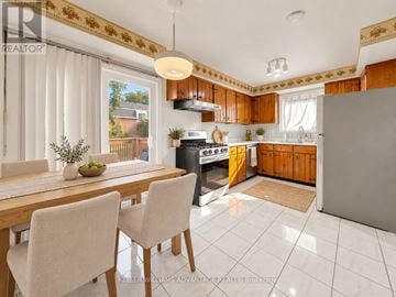 Toronto (Steeles) apartment for rent - A kitchen with a table and chairs in front of a window.
