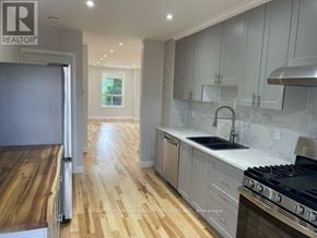 Toronto (Dovercourt-Wallace Emerson-Junction) duplex for rent - A modern kitchen with wooden floors and stainless steel appliances.