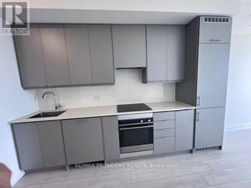 Mississauga (Fairview) condo for rent - A modern kitchen with grey cabinets and stainless steel appliances.