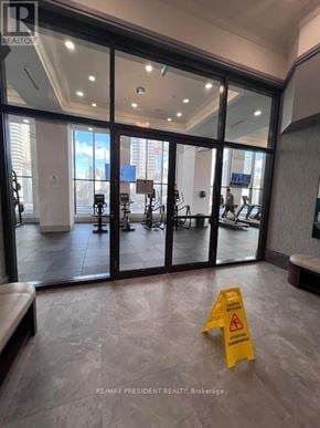 Mississauga (Fairview) condo for rent - A yellow caution sign is on the floor of a building entrance.