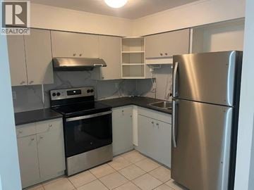 Port Moody townhouse for rent - A kitchen with a stainless steel refrigerator, oven, and sink.