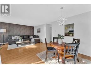 North Vancouver townhouse for rent - A modern living room with a wooden floor and a grey sofa.