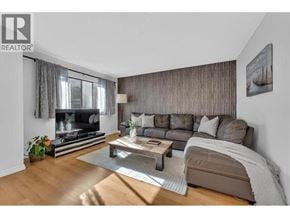 North Vancouver townhouse for rent - A modern living room with a fireplace and a large couch.