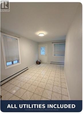 Toronto (Mimico) apartment for rent - A room with tiled flooring and a window with blinds.