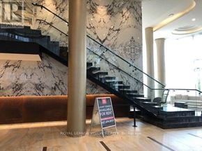 Toronto (Bayview Village) condo for rent - A marble staircase with a sign that says "Available for Rent" in the foreground.