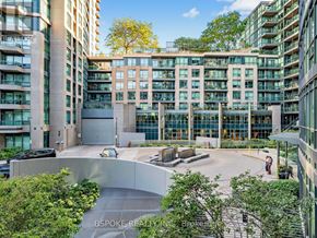 Toronto (Niagara) condo for rent - A modern building with a courtyard surrounded by other buildings.