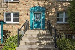 London South (South F) multi-family for rent - A blue door is the centerpiece of this brick building.