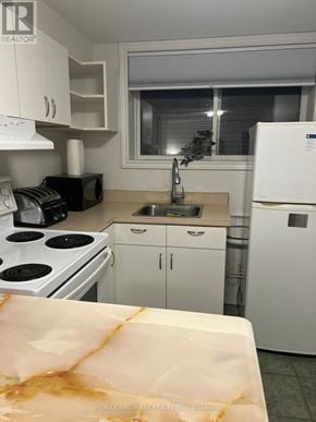 Whitby (Lynde Creek) apartment for rent - A kitchen with white appliances and cabinets.