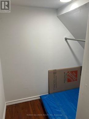 Whitby (Lynde Creek) apartment for rent - A room with a white wall and a blue tarp on the floor.