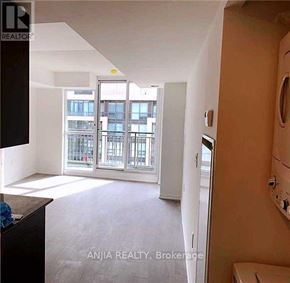 Toronto (Bendale) condo for rent - A room with a view of a cityscape through large windows.