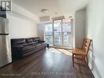 Toronto (Bendale) condo for rent - A living room with a black leather couch and wooden floors.