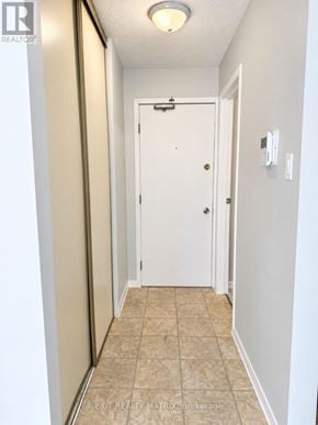 Casselman multi-family for rent - A hallway with a white door and tiled floor.