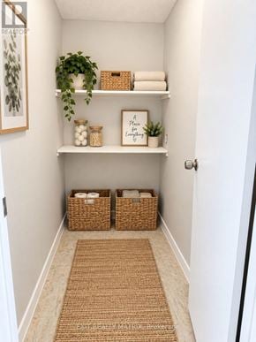 Casselman multi-family for rent - A hallway with a rug and baskets on the floor.