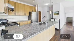 Surrey apartment for rent - A kitchen with granite countertops and wooden cabinets.