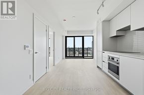 Toronto (Thorncliffe Park) condo for rent - A modern kitchen with white cabinets and a view of the city.
