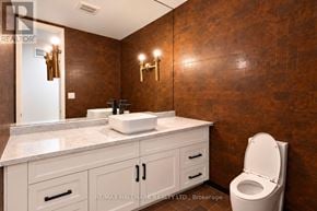 Toronto (Bridle Path-Sunnybrook-York Mills) apartment for rent - A bathroom with a brown wall and a white toilet.