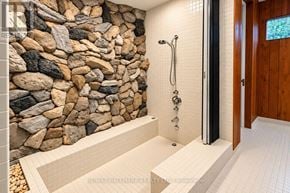 Toronto (Bridle Path-Sunnybrook-York Mills) apartment for rent - A bathroom with a stone wall and a walk-in shower.