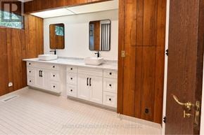 Toronto (Bridle Path-Sunnybrook-York Mills) apartment for rent - A bathroom with a sink, mirror, and wooden door.