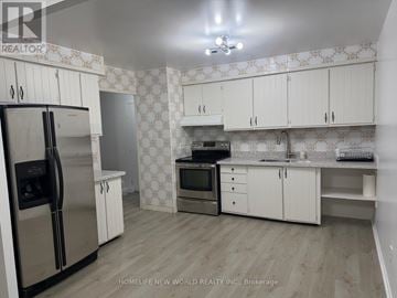 Toronto (Hillcrest Village) townhouse for rent - A kitchen with white cabinets and a patterned backsplash.
