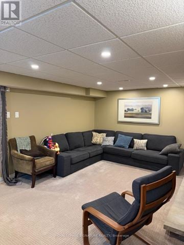 Oakville (Wo West) apartment for rent - A living room with a grey couch, a brown chair and a painting on the wall.