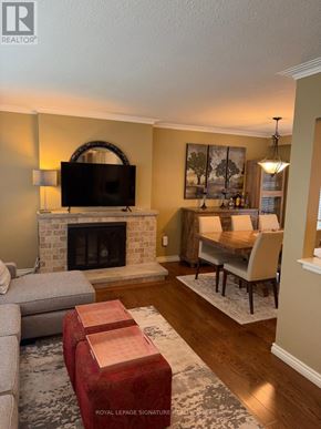 Oakville (Wo West) apartment for rent - A living room with a fireplace and a television.