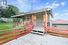 Prince Edward County (Picton Ward) apartment for rent - A house with a red fence and a porch.