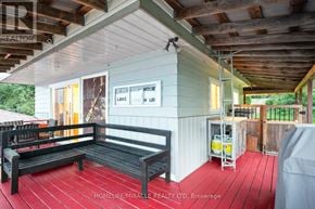 Prince Edward County (Picton Ward) apartment for rent - A wooden deck with a bench and a sign that says "BEST SELLER".